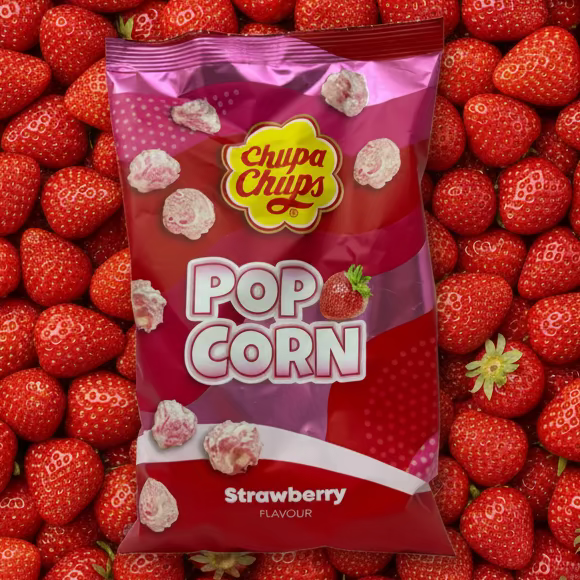 Chupa Chups Popcorn Strawberry (UK) - 90g laying on a field of strawberries